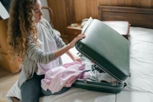 woman packing suitcase to prepare for air travel