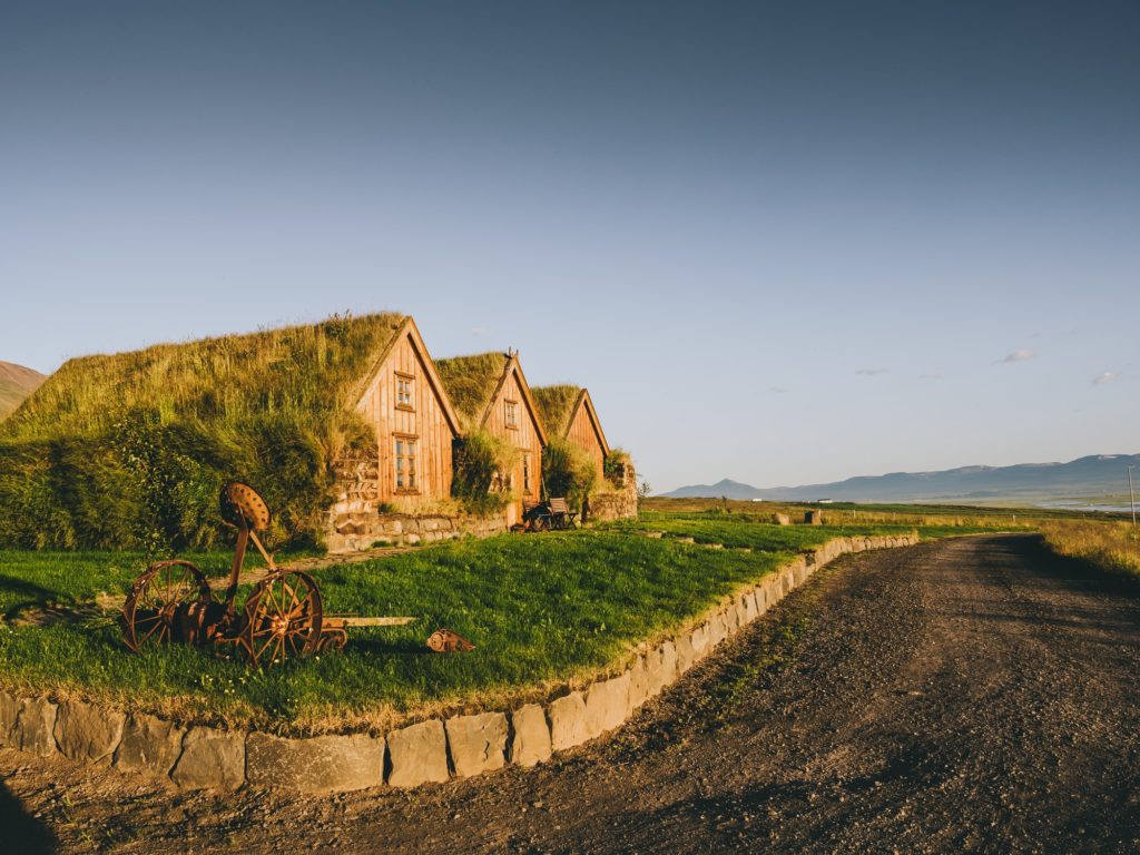road and traditional icelandic houses with grass roofs, Iceland
