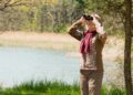 Senior woman in a Birdwatching Safari Using Binoculars