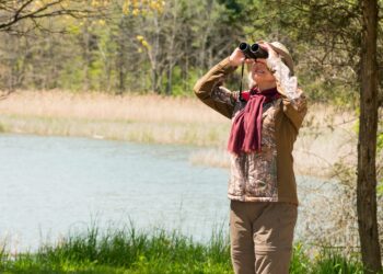 Birdwatching Safari: Active Senior Woman Using Binoculars (Source: Canva)
