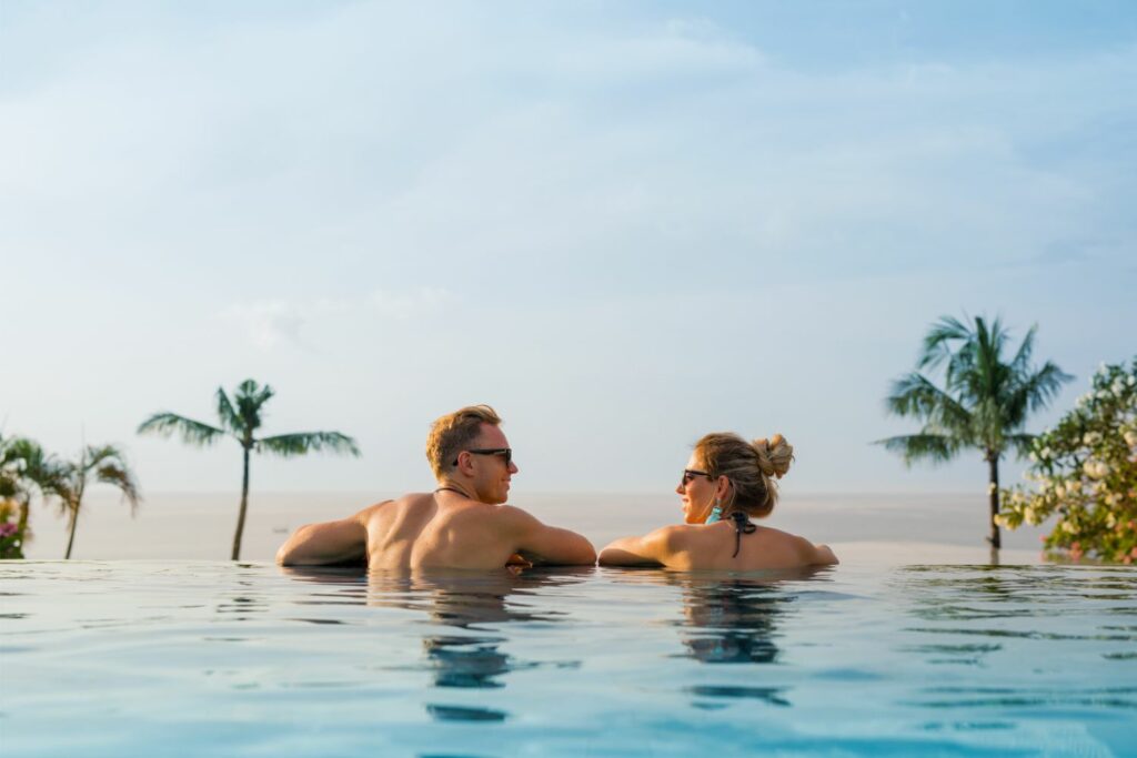 Couple enjoying private pool with ocean view