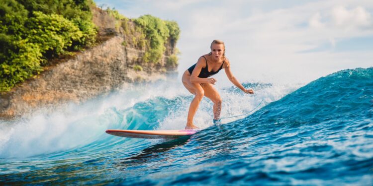 woman catching waves at one of the best water sports beaches