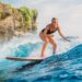 woman catching waves at one of the best water sports beaches