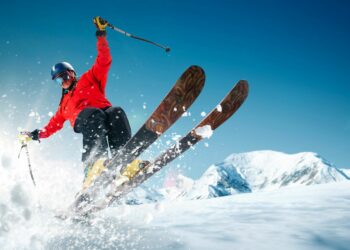 Man skiing in snowy mountains in skiing and spa resort