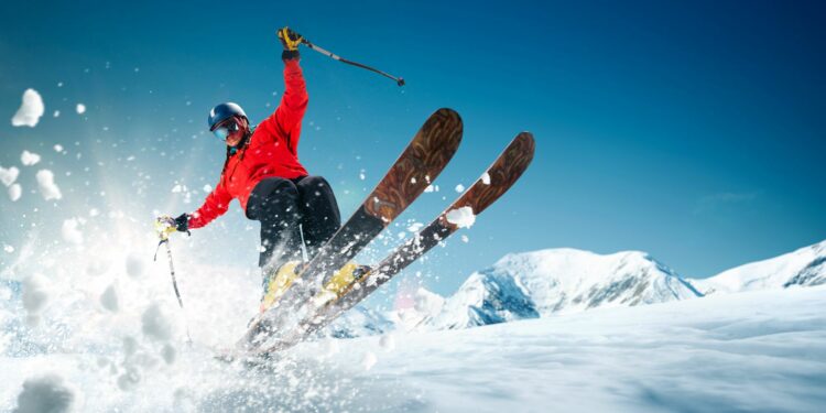 Man skiing in snowy mountains in skiing and spa resort