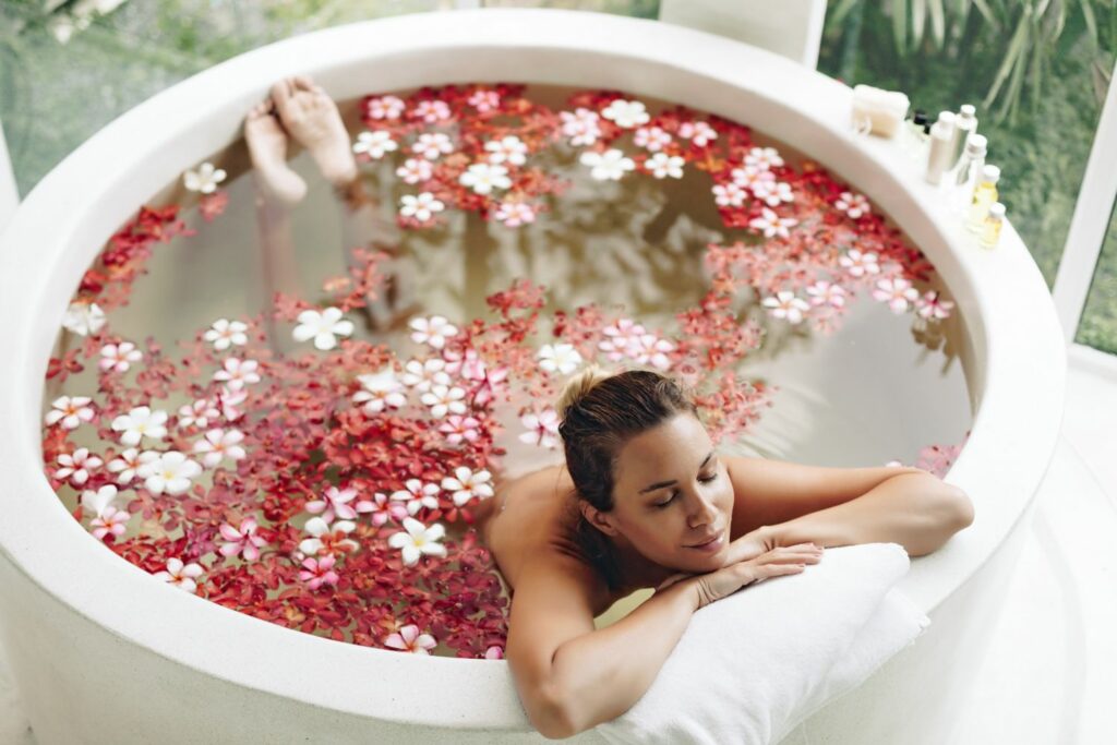 Woman enjoying flower bath at luxurious spa resort
