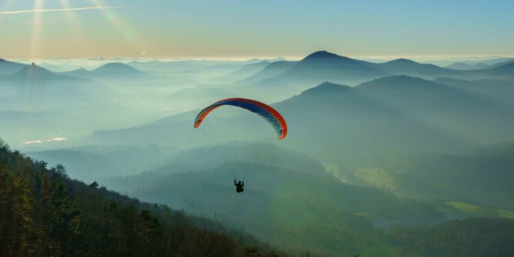 Paraglider Soaring On Top Of The Mountains: Best Locations for Paragliding (Source: Canva)