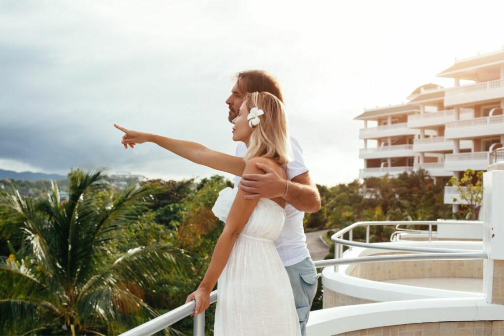 Couples In The Balcony Of A Resort (Source: Canva)