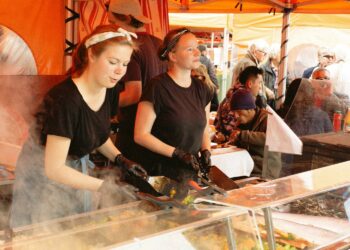 Women In Black Shirt Selling In Food Festivals and Markets (Source: Canva)