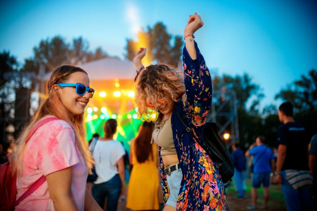 Friends Dancing and Enjoying at One of The Best Music Festivals in the UK and Scandinavia (Source: Canva)