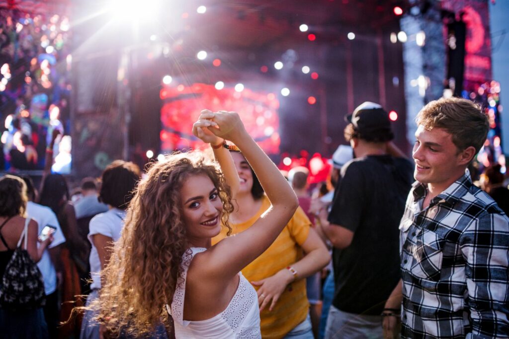 Group of Friends Enjoying The Best Music Festival In Front of The Stage (Source: Canva)