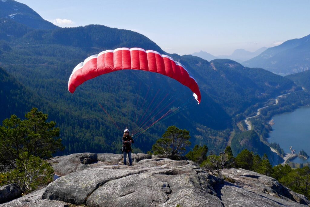 Paraglider On  Top Of The Mountain Preparing To Take Off (Source: Canva)