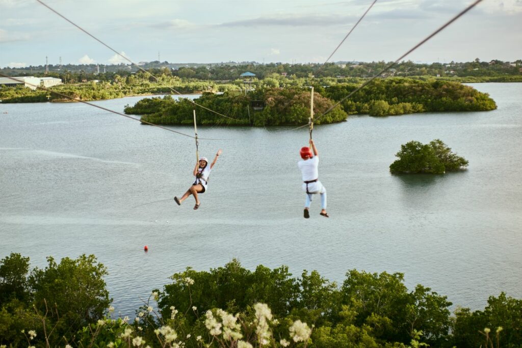 People Ziplining Above The Lake (Source: Canva)