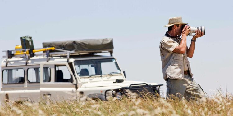 Male Photographer Shooting With His Camera On African Photography Safaris (Source: Canva)