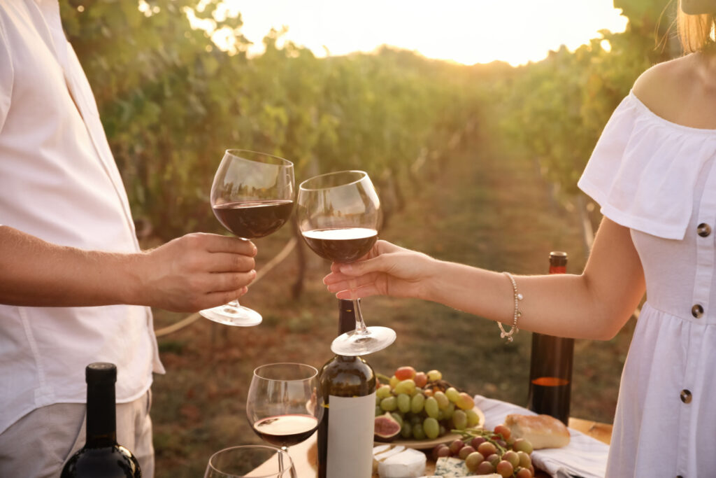 couple enjoying wine in vineyard, hunter valley wineries, sunny day