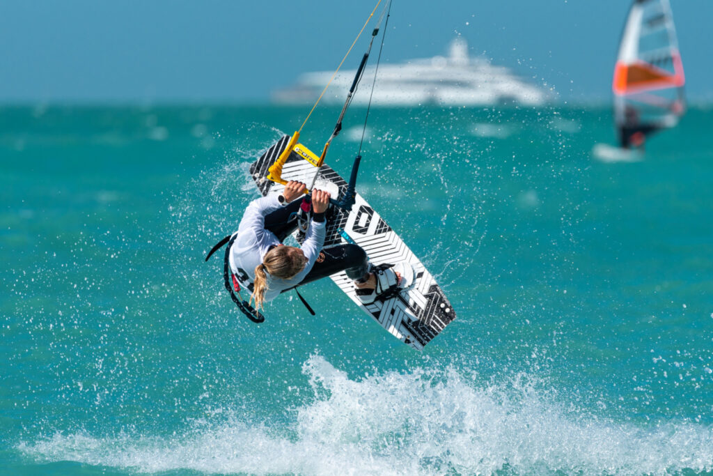 Kitesurfer showcasing a unique trick in the competition