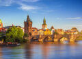 Scenic spring sunset aerial view of the Old Town pier architecture and Charles Bridge over Vltava river in Prague, Czech Republic - DaLiu/Shutterstock