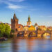 Scenic spring sunset aerial view of the Old Town pier architecture and Charles Bridge over Vltava river in Prague, Czech Republic - DaLiu/Shutterstock