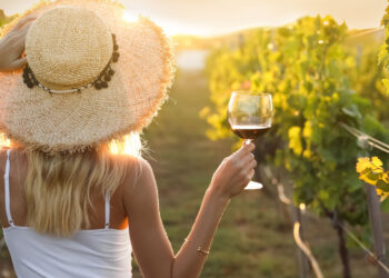 woman enjoying wine in vineyard, hunter valley wineries, sunny day