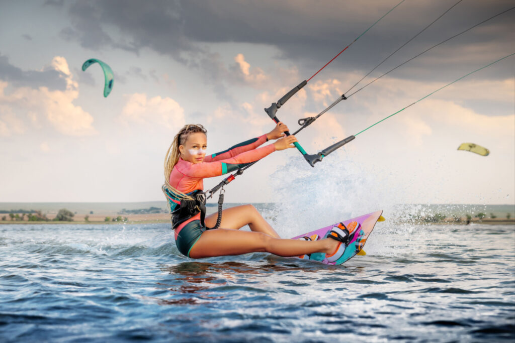 Professional kite surfer woman riding board with plank on Lake Leman