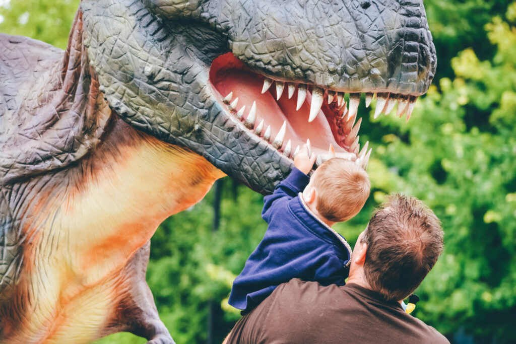 experience the best amusement parks in the midwest as a child amazed by dinosaur sculpture