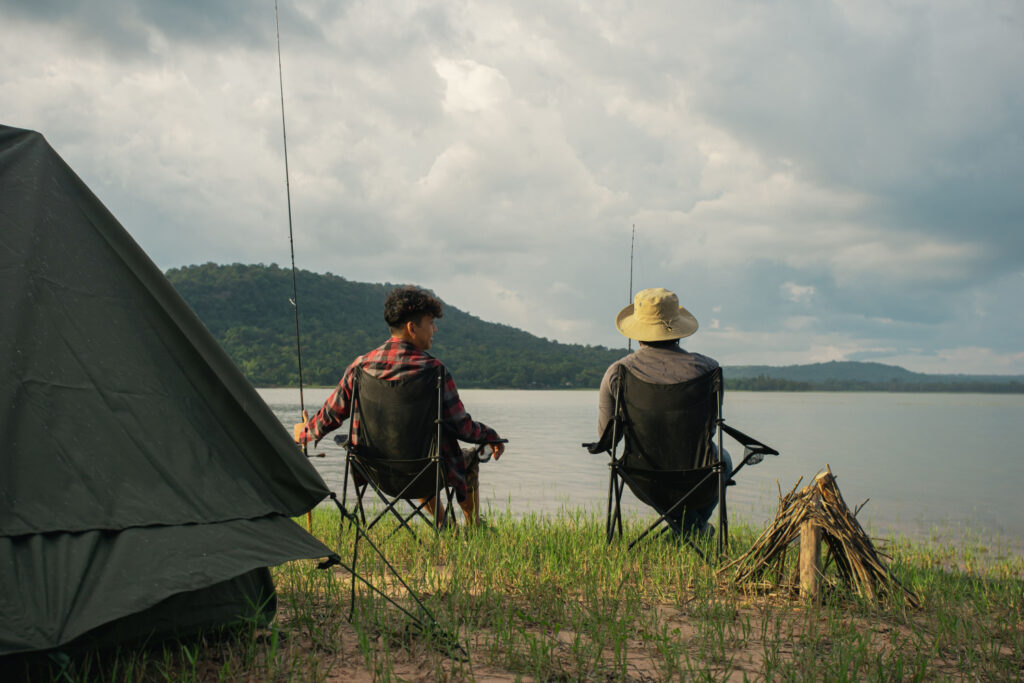 two men camping across the country and fishing by the lake