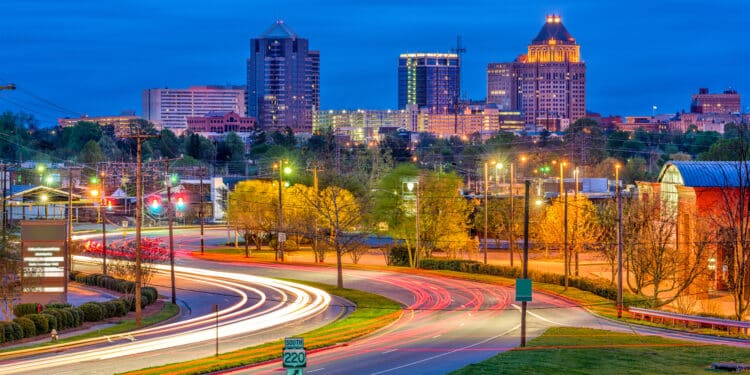 Greensboro, North Carolina, USA downtown skyline and highways.