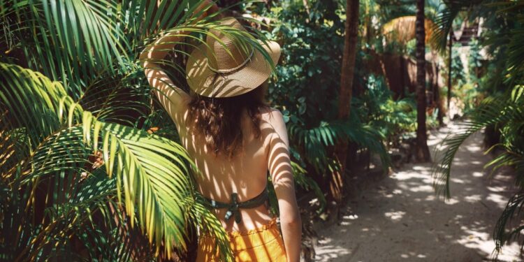 Girl walking on the tropical greenery in Tulum - Where is Tulum?