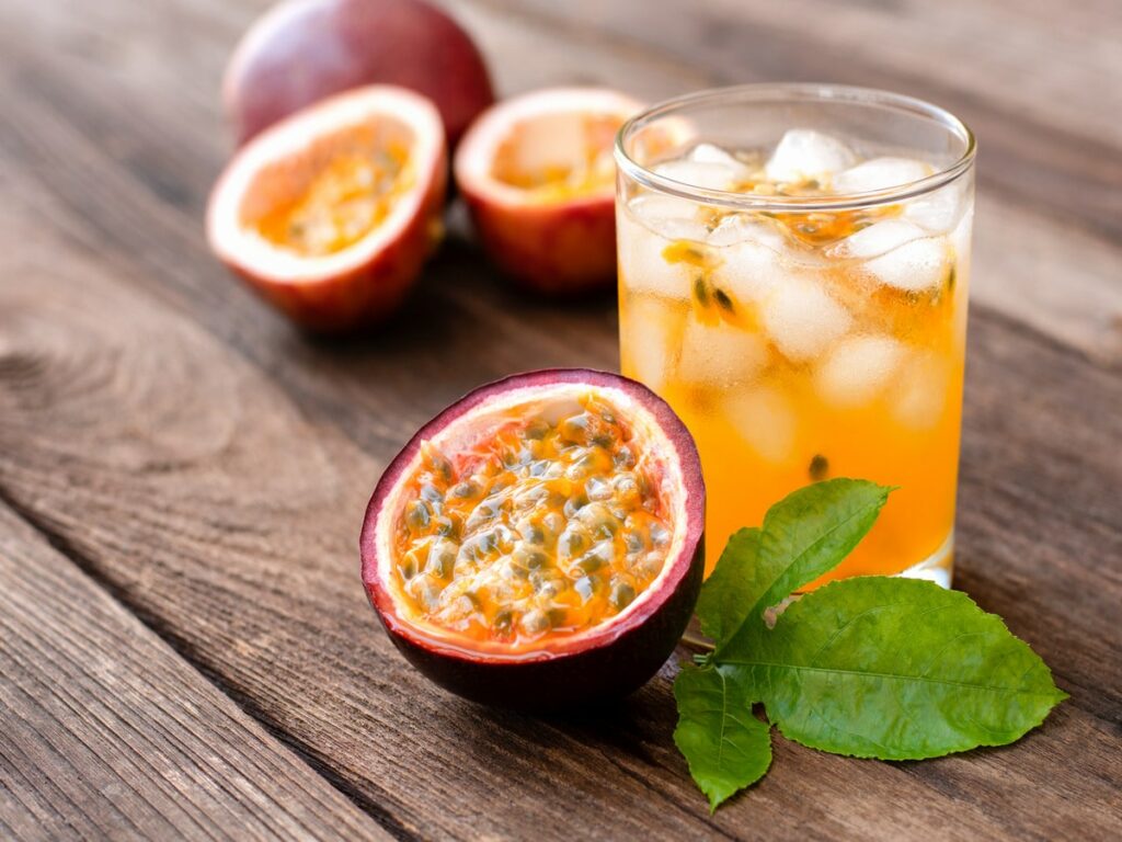 Passionfruit juice in glass and fresh passion fruit