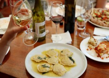 Ravioli with Glass of White Wine, a food from Northern Italy
