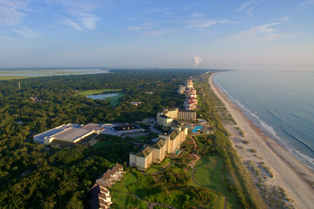 Aerial view of luxurious hotels with swimming pools alongside Amelia Island, Florida