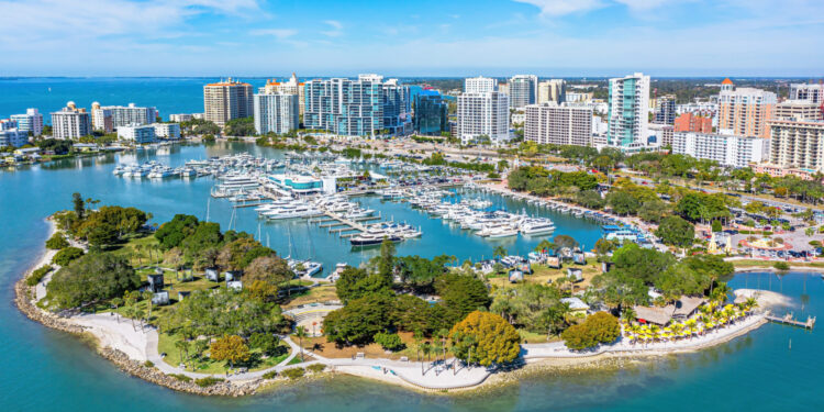 Aerial view showcasing Downtown Sarasota, Florida, Bayfront Park, Marina Jack, and the striking Golden Gate