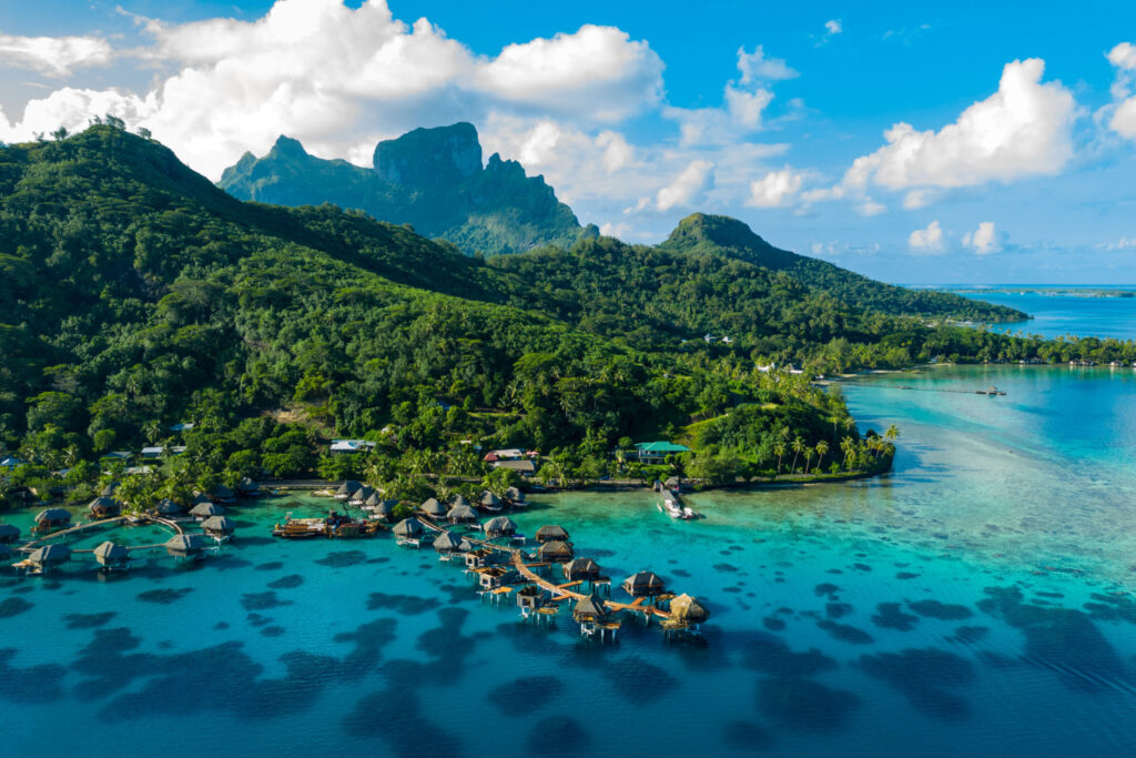 Bora Bora aerial view with overwater bungalows luxury resort, coral reef lagoon ocean beach