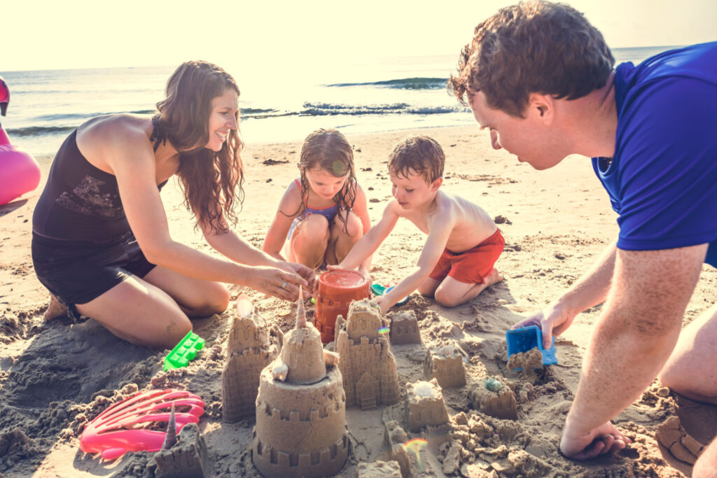 Family building sand castle on one of beaches in Houston Tx