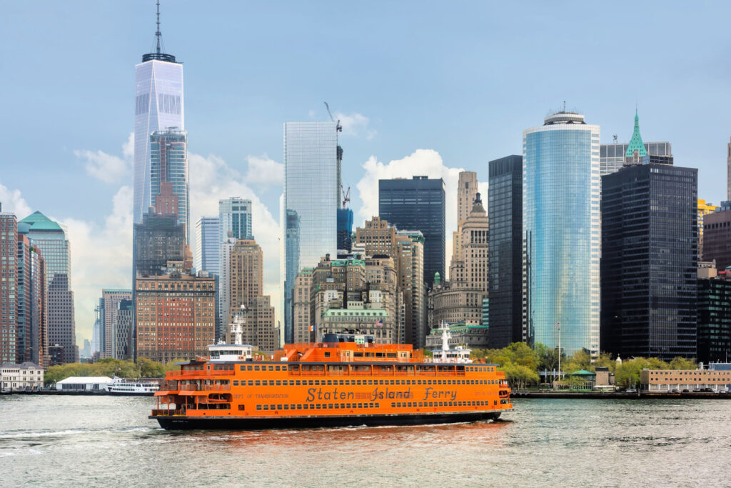 staten island ferry on the new york harbor against of lower manhattan skyscrapers