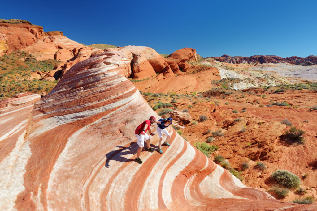 young couple day trips from las vegas exploring amazing sandstone formations in valley of fire state park