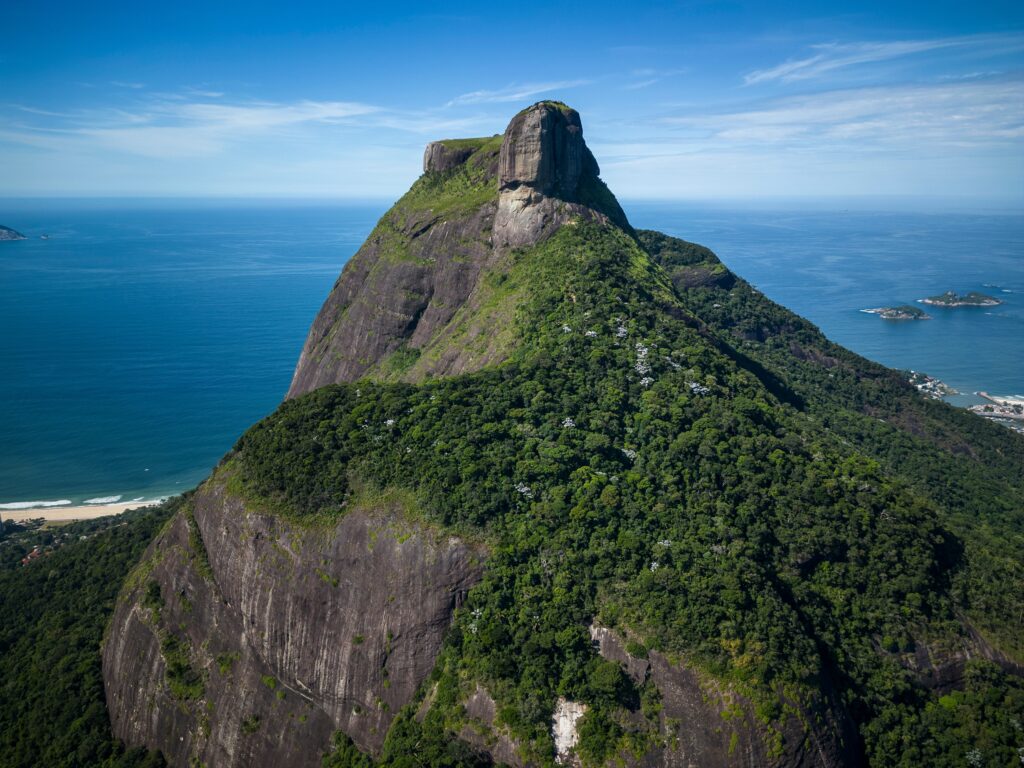 Beautiful aerial view of green rocky rainforest Pedra da Gávea mountain in Tijuca Forest, Rio de Janeiro, Brazil.  vitormarigo/Shutterstock