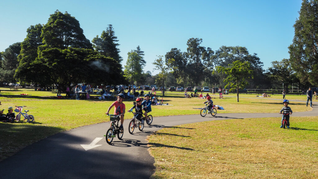 Children enjoy riding a bicycle at Centennial Park as they exercise in the winter sunshine.  SAKARET/Shutterstock