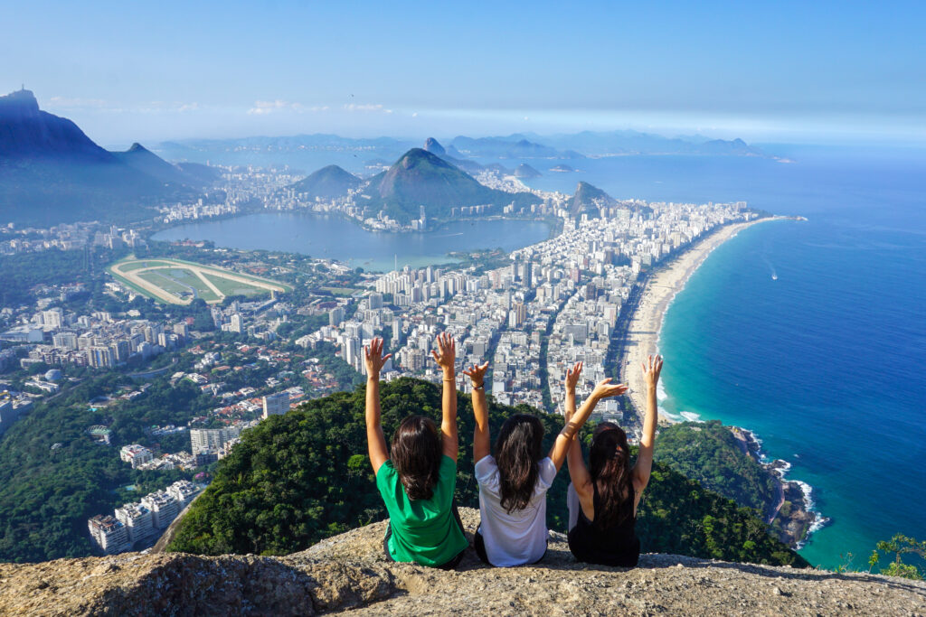 Three friends at the summit of The Two Brothers Hill (Morro Dois Irmãos), Rio de Janeiro City