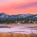 Big Bear Lake view with a snowy mountain and a pink and purple sky at dusk